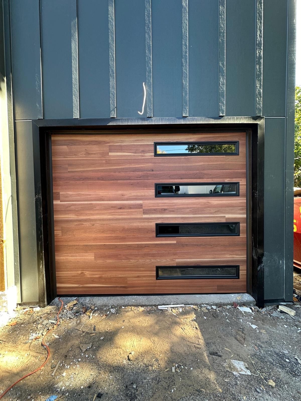 New Door Installation - Modern Walnut Wood Door with Slim Windows in Montclair completed in Montclair, NJ, NJ by Ez2Fix Garage Door Repair